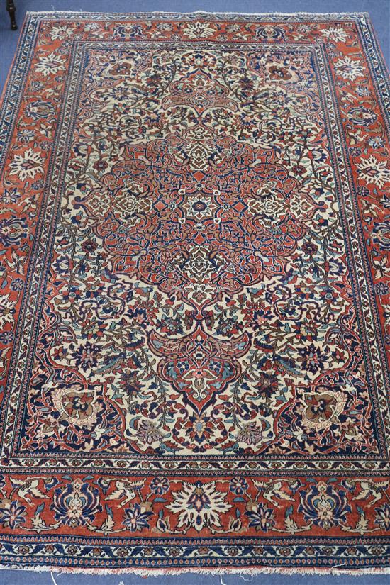 An Isphahan red and cream medallion rug 240 x 140cm